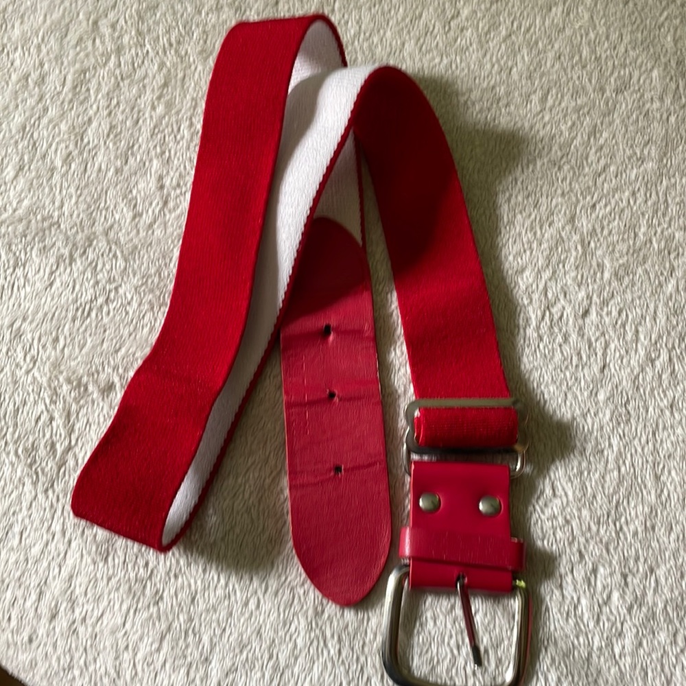 Red adjustable baseball belt. Fits 32” waist and smaller.